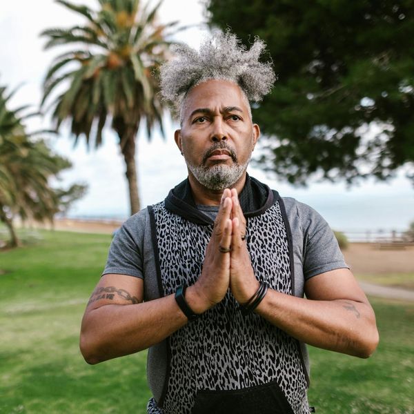 Person finding balance in a standing yoga pose outdoors.